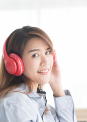 Naklejka premium Young beauty asian woman listening music from headphone in the morning, Bedroom background