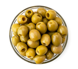 Green olives in a glass plate on a white. The form of the top.