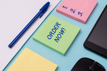 Handwriting text writing Order Now. Conceptual photo confirmed request by one party to another to buy sell Note papers and stationary plus gadgets placed sideways above backdrop