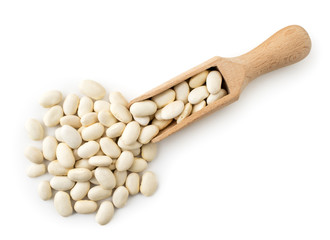 White beans spilled from a wooden spoon. The form of the top.