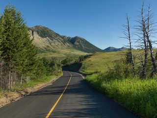 Road leading towards mountain, Red Rock Canyon Parkway, Waterton Lakes National Park, Alberta,...