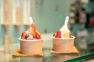 Ice cream with fresh berries in paper cup Street food