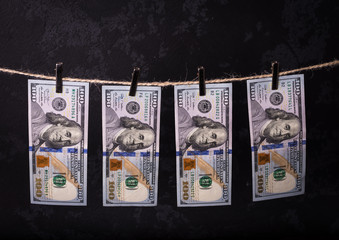 Fototapeta na wymiar Money Laundering. Money Laundering US dollars hung out to dry. 100 dollar bills hanging on clotheslines