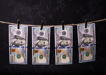 Fototapeta premium Money Laundering. Money Laundering US dollars hung out to dry. 100 dollar bills hanging on clotheslines