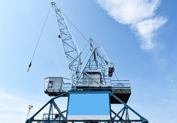 Harbour crane on which an empty advertising poster is attached for self-labelling