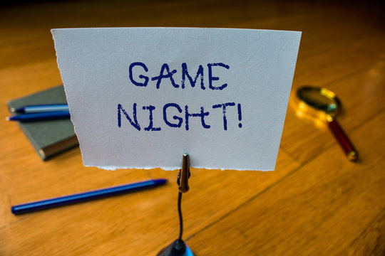 Writing note showing Game Night. Business concept for usually its called on adult play dates like poker with friends Reminder paper base note rule pen magnifying glass electronic device
