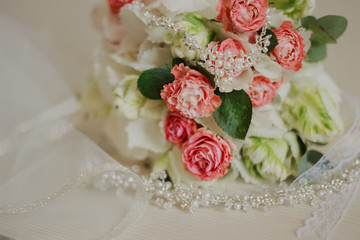 Beautiful modern wedding bouquet on a white table. Wedding attributes. No people