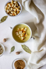 Cheese cream soup on a white background. White bread croutons. Ingredients.