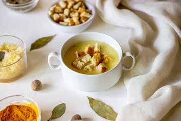 Cheese cream soup on a white background. White bread croutons. Ingredients.