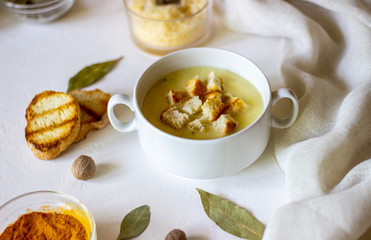 Cheese cream soup on a white background. White bread croutons. Ingredients.