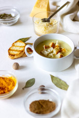 Cheese cream soup on a white background. White bread croutons. Ingredients.