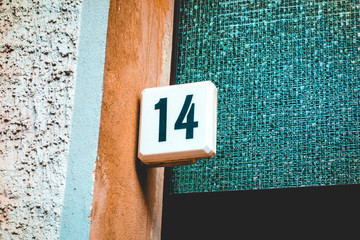 number 14 door sign on mosaik background