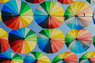 Colorful razchetsetnye umbrellas against the sky, toned.