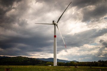 Fototapeta premium Wind generator turbine or windmill or wind farm on meadow