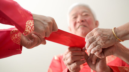 Hand giving red envelop for Chinese new year festival