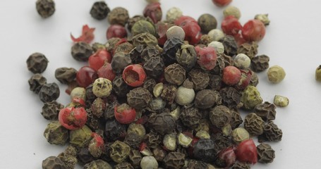 Mix of multicolored pepper. Peas with spices. Macro on white background