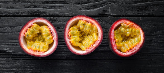 Passion fruits on a wooden background. Tropical Fruits. Top view. Free space for text.