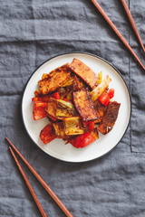 Szechuan traditional dish Hui Guo Rou, spicy roasted pork with leek and bell pepper. Portion size, top view.