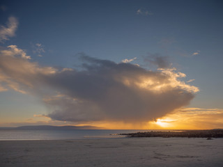 Atlantic ocean, sunset time, Galway bay, Burren mountains silhouette in the background. Ireland.