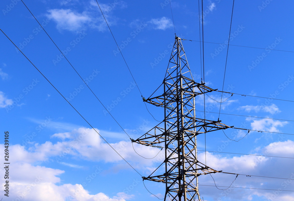 Wall mural high voltage power line tower on blue sky with clouds background