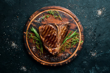 Grilled Steak on a stone table. Top view. Free space for text.