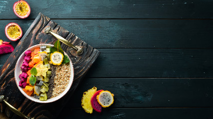 Oatmeal with tropical fruit. Top view. Free space for text.