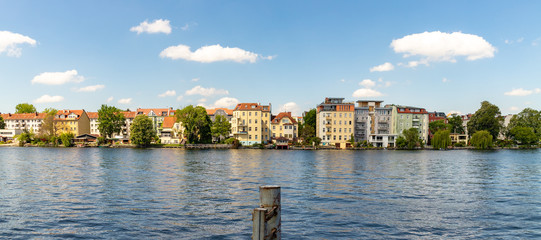 Fototapeta na wymiar Romantic views of the river Dahme and Spree in Berlin Koepenick with houses on the shore, bridges, ships and boats