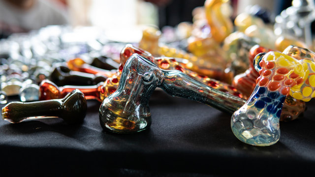 glass smoking pipes on a black background. Design accessories for smoking marijuana.