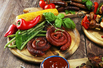 Assorted delicious grilled meat and skewer with vegetable on rustic table