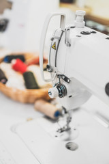Sewing concept. Sewing machine and spool threads.