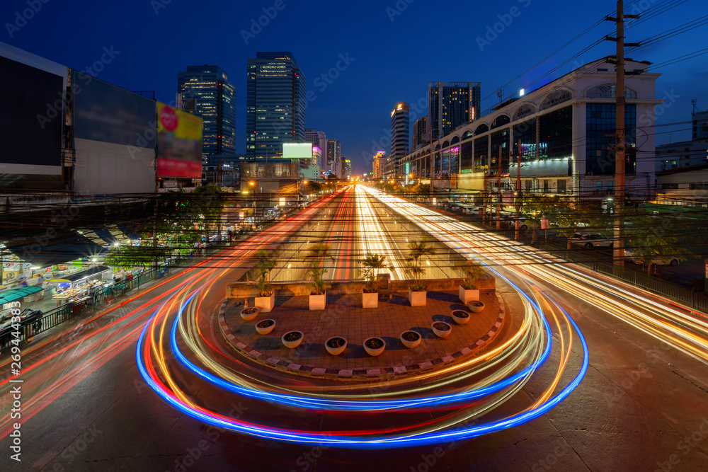 Wall mural Car lights with U turn road in Sutthisan district with architecture buildings in transportation concept. Urban city, Bangkok at night, Thailand. - Wall murals