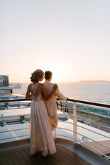 Young beautiful couple on the deck of a cruise liner in the sea