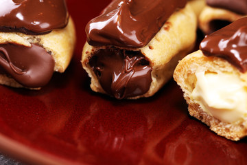 Traditional French dessert. Eclair with chocolate icing. Pastery concept with chocolate eclair