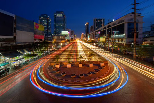 Car Lights With U Turn Road In Sutthisan District With Architecture Buildings In Transportation Concept. Urban City, Bangkok At Night, Thailand.