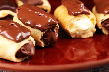 Traditional French dessert. Eclair with chocolate icing. Pastery concept with chocolate eclair