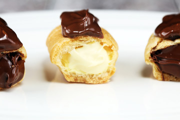 Traditional French dessert. Eclair with chocolate icing. Pastery concept with chocolate eclair