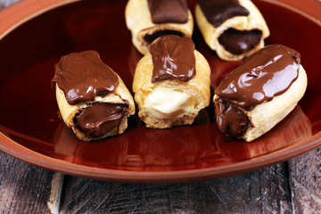 Traditional French dessert. Eclair with chocolate icing. Pastery concept with chocolate eclair