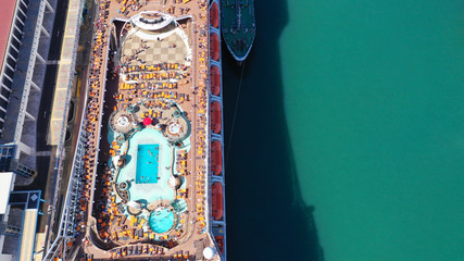 Aerial top view photo of crowded open sun deck with large pool and facilities of cruise ship liner...