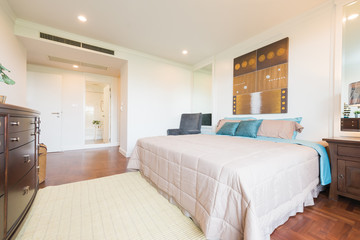 Stylish apartment interior with white walls and herringbone wooden floor.