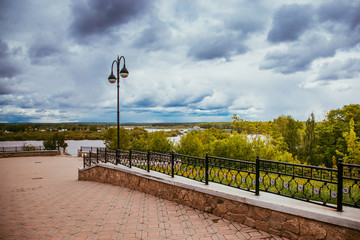 deserted city embankment on a cloudy summer day