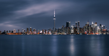 Toronto city at night skyscrapers and office buildings in the downtown financial district at dusk view from the Toronto islands Panorama