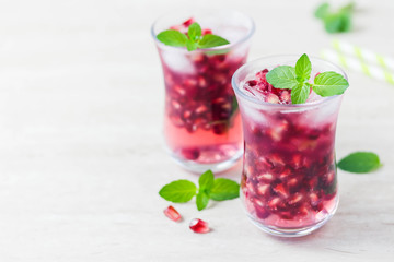 Mint pomegranate sparkling infused water. Selective focus, space for text.