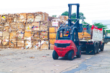 Bangkok/Thailand-May 23,2019:  Thai recycle industry cardboard garbage and paper waste after pressing in hydraulic baling garbage press machine to a square dense for transportation to recycle factory 