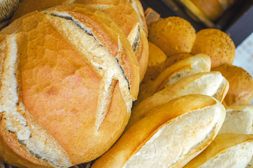 Fresh loaf of white bread. White bread on the showcase in the bakery. Hot baking. Bakery products made from wheat flour. Selective focus image, background, copy space.