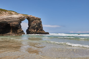 Stone bridge on the beach of the cathedrals, Spain