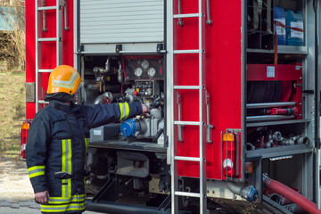 fireman work with firetruck equipment