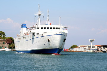 Large ferry entering the narrow opening of Ischia Port, Ischia near Naples, Italy.