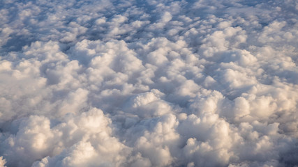 The beautiful cloudscape with clear blue sky. A view from airplane window.