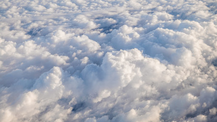 The beautiful cloudscape with clear blue sky. A view from airplane window.