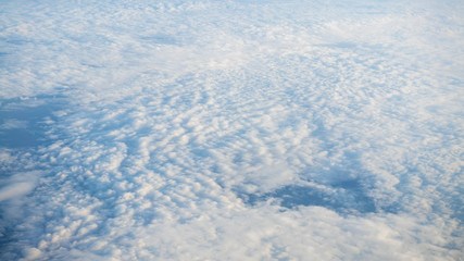 The beautiful cloudscape with clear blue sky. A view from airplane window.